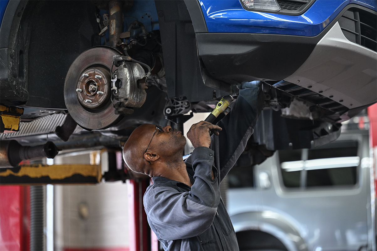 Mechanic working on a car in a shop